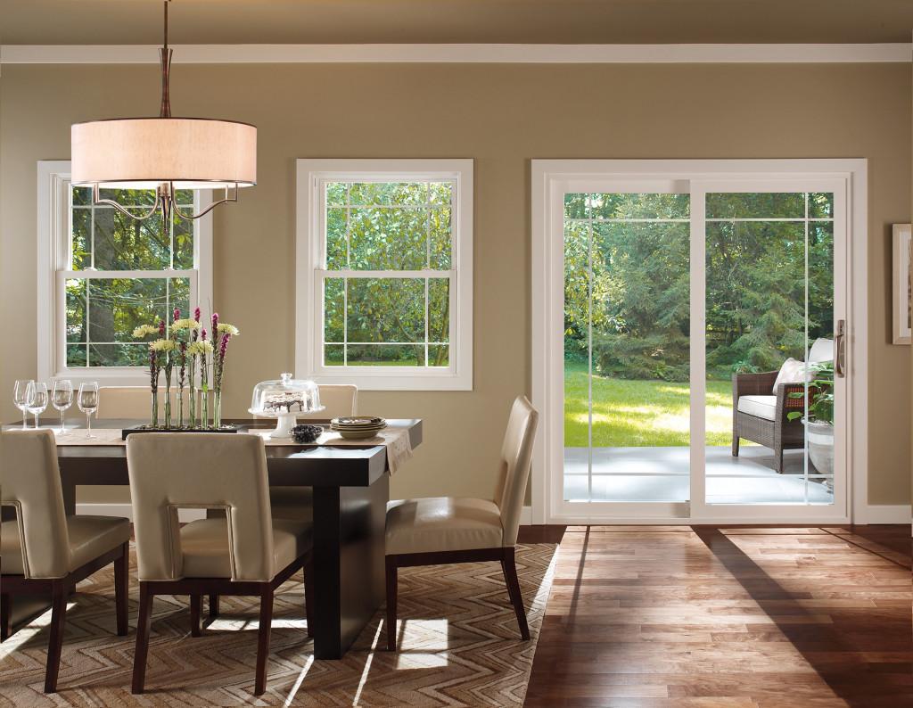 Replacement windows and patio door in a bright dining room